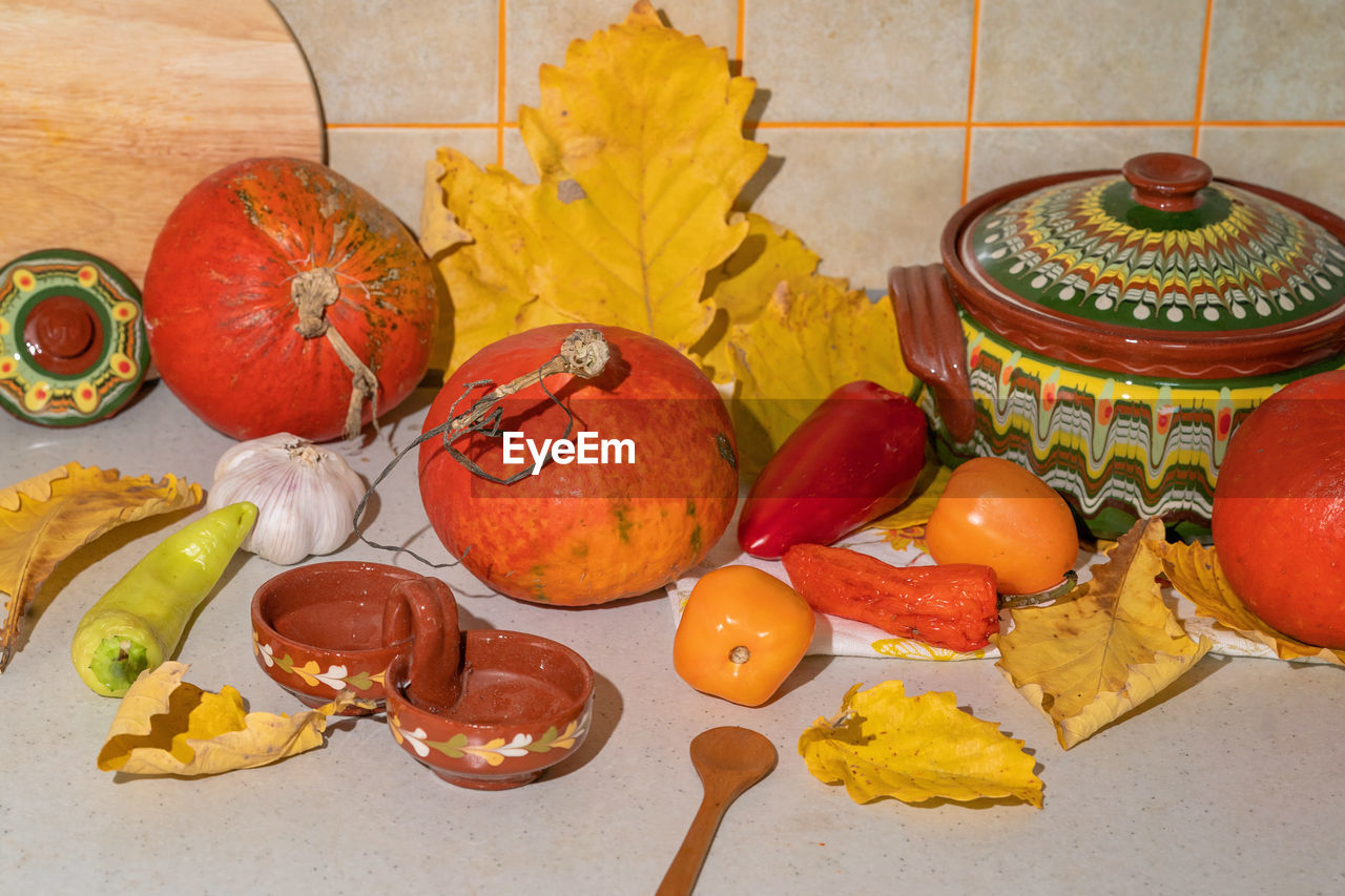 food, food and drink, fruit, healthy eating, produce, no people, indoors, wellbeing, high angle view, table, still life, tradition, celebration, pumpkin, freshness, meal, orange, dish, orange color, autumn, vegetable, kitchen utensil, container, household equipment