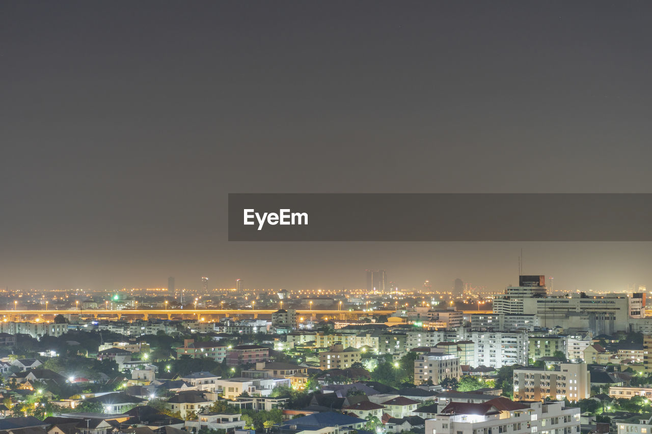 Aerial view of illuminated cityscape against sky at night