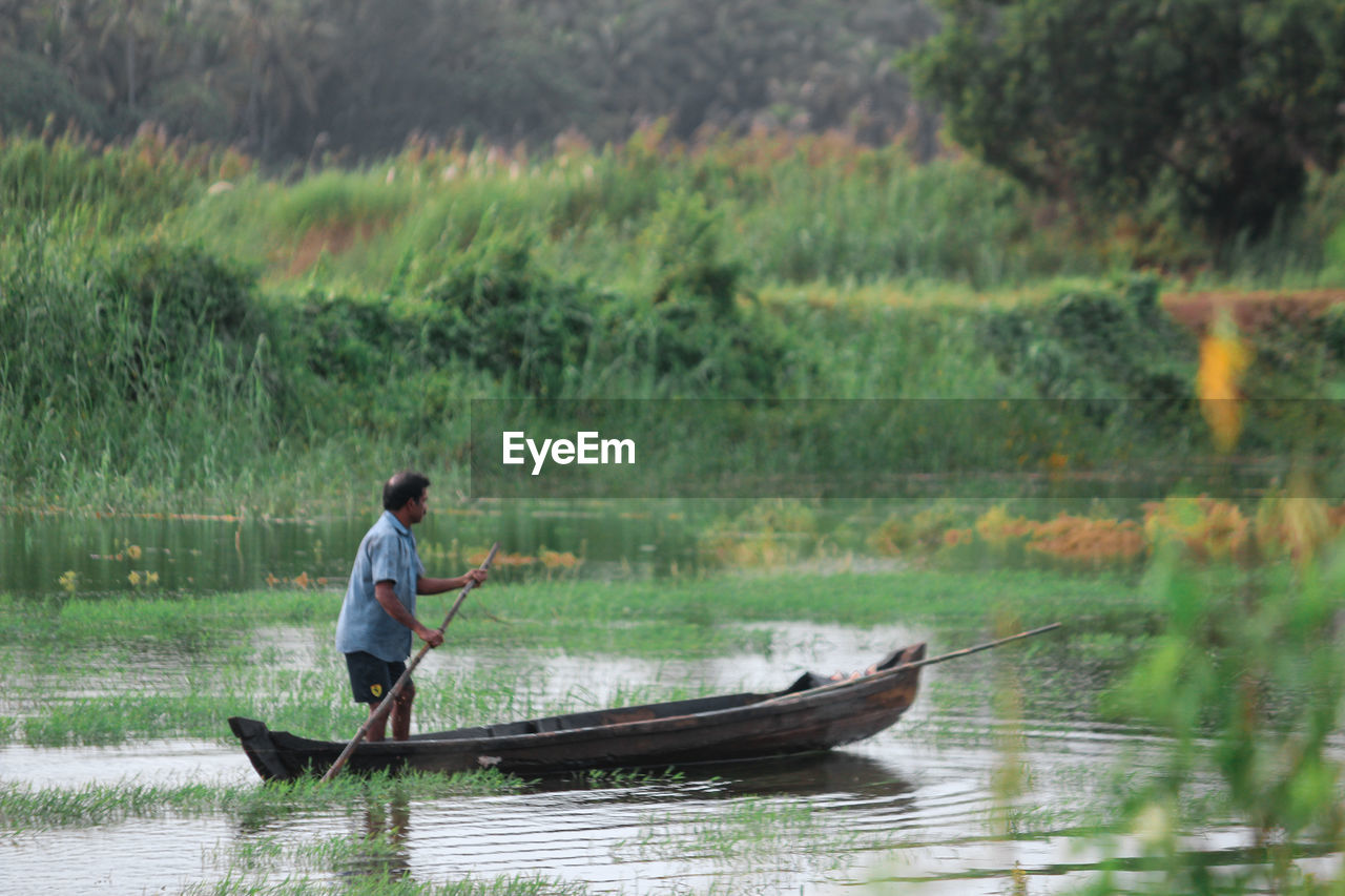 Man rowing boat on lake