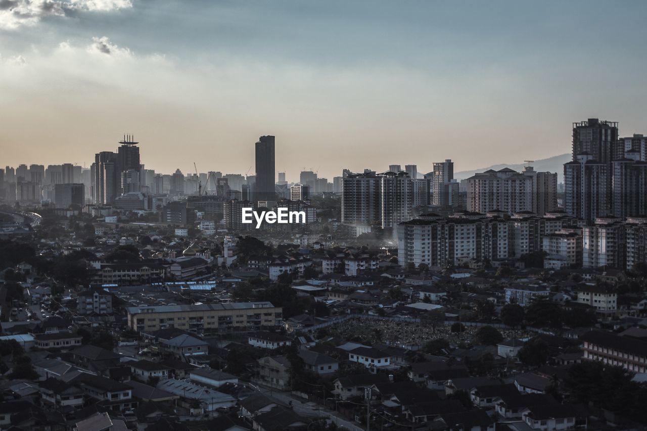  modern buildings in city against sky during sunset