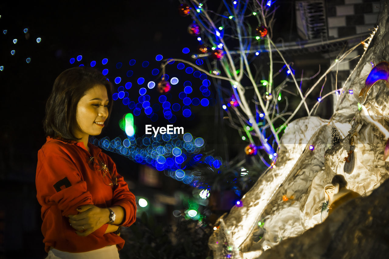 one person, night, illuminated, christmas lights, decoration, child, childhood, celebration, christmas decoration, holiday, standing, christmas, women, multi colored, tree, nature, looking, christmas tree, waist up, three quarter length, outdoors, female, glowing, lifestyles
