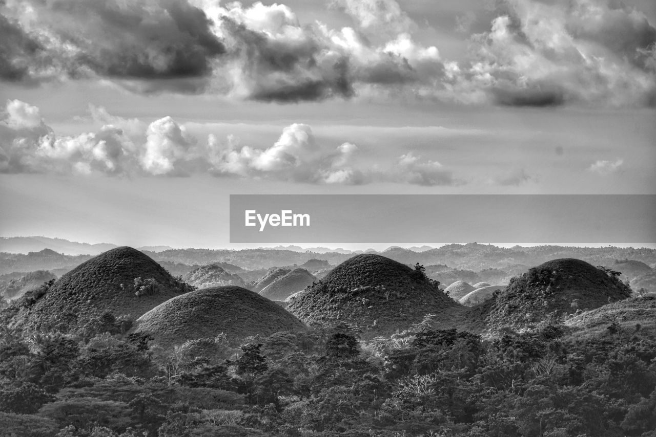 SCENIC VIEW OF LANDSCAPE AND MOUNTAINS AGAINST SKY