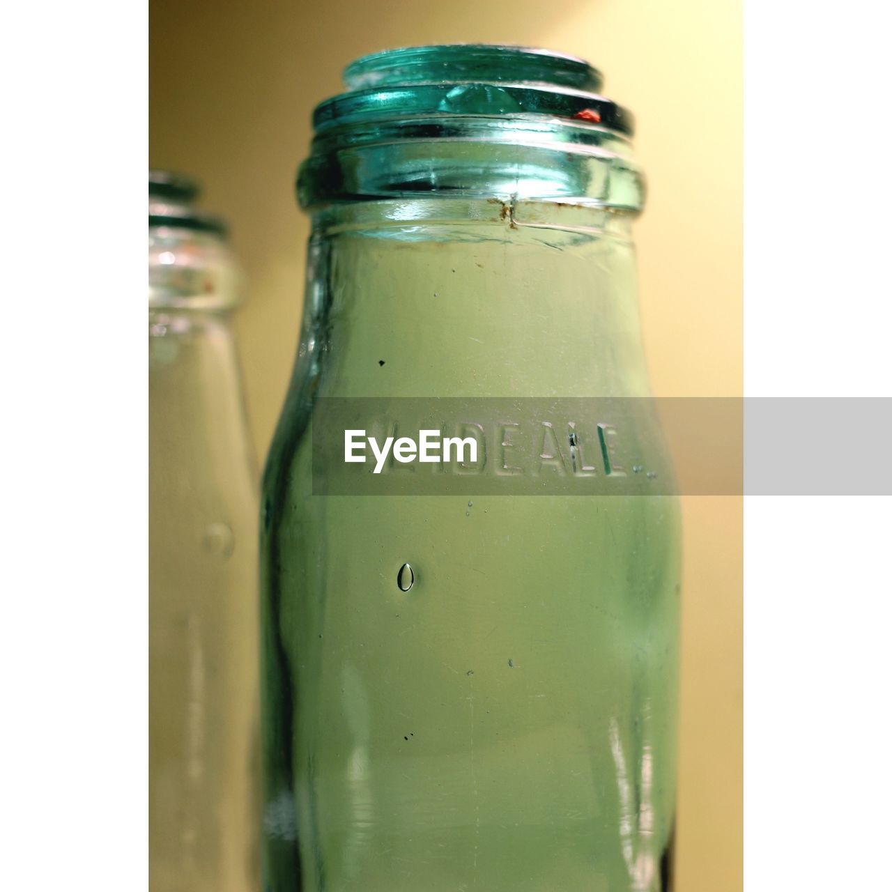 CLOSE-UP OF BOTTLE IN GLASS