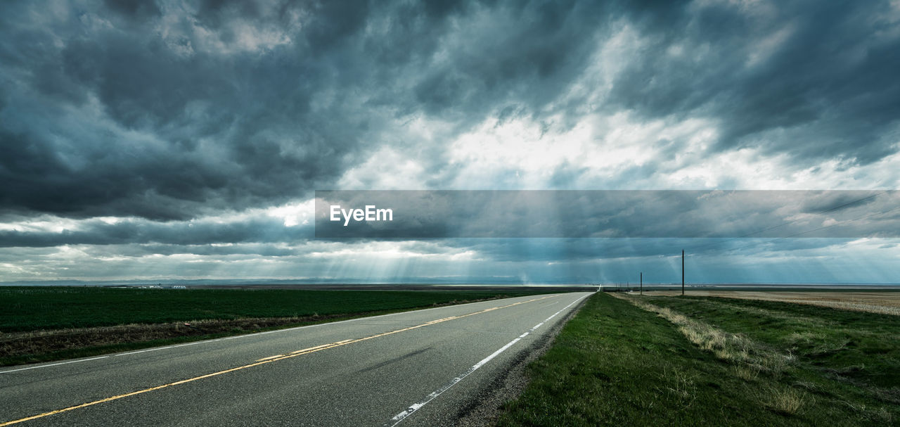 ROAD PASSING THROUGH LANDSCAPE AGAINST SKY