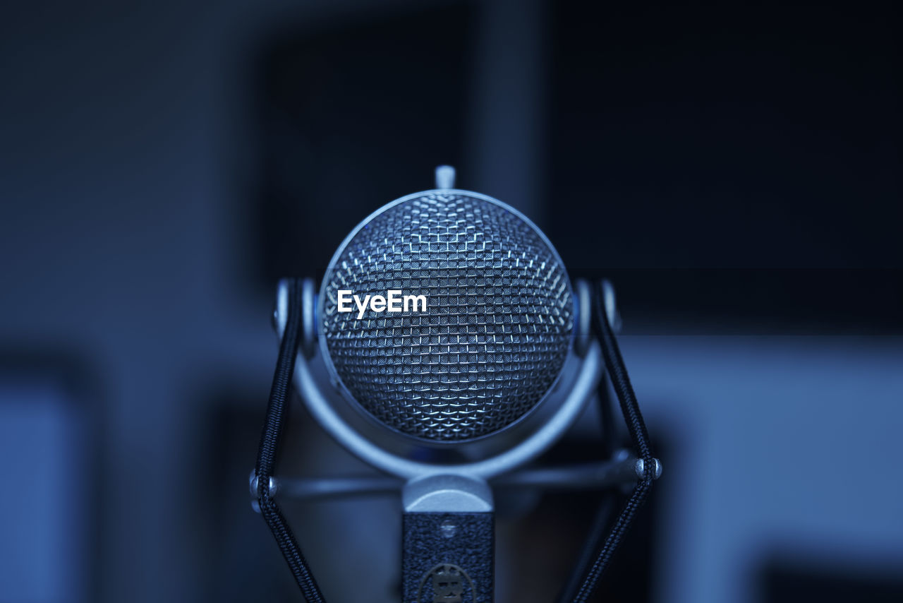 Close-up of microphone against blurred background