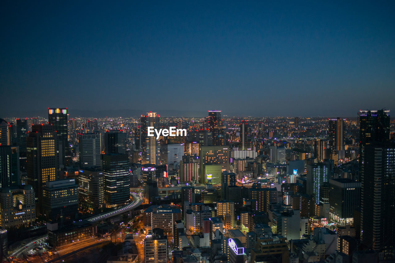 Aerial view of osaka by night. skyscrapers and the city in the distance. japan, asia