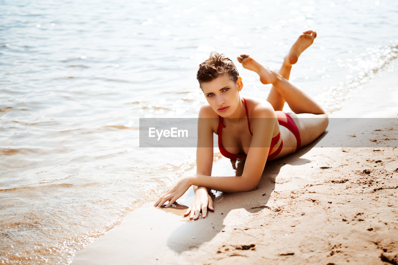 Portrait of sensuous model in bikini posing at beach