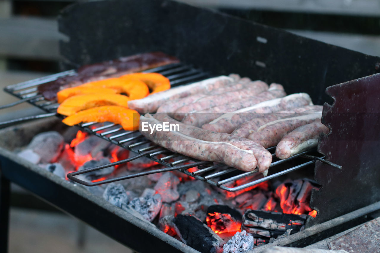 High angle view of bratwurst on barbecue grill