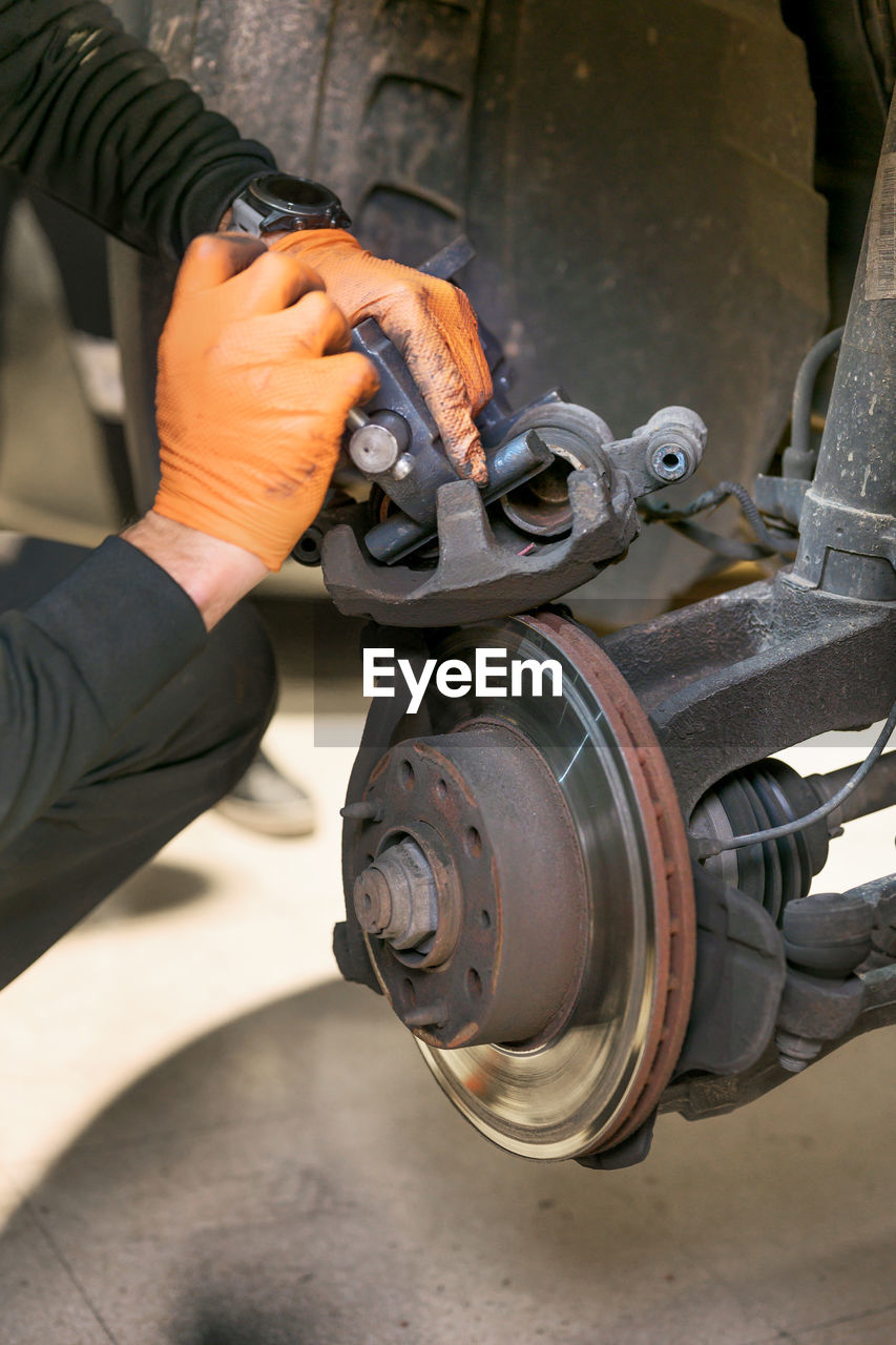 MIDSECTION OF MAN WORKING ON METAL