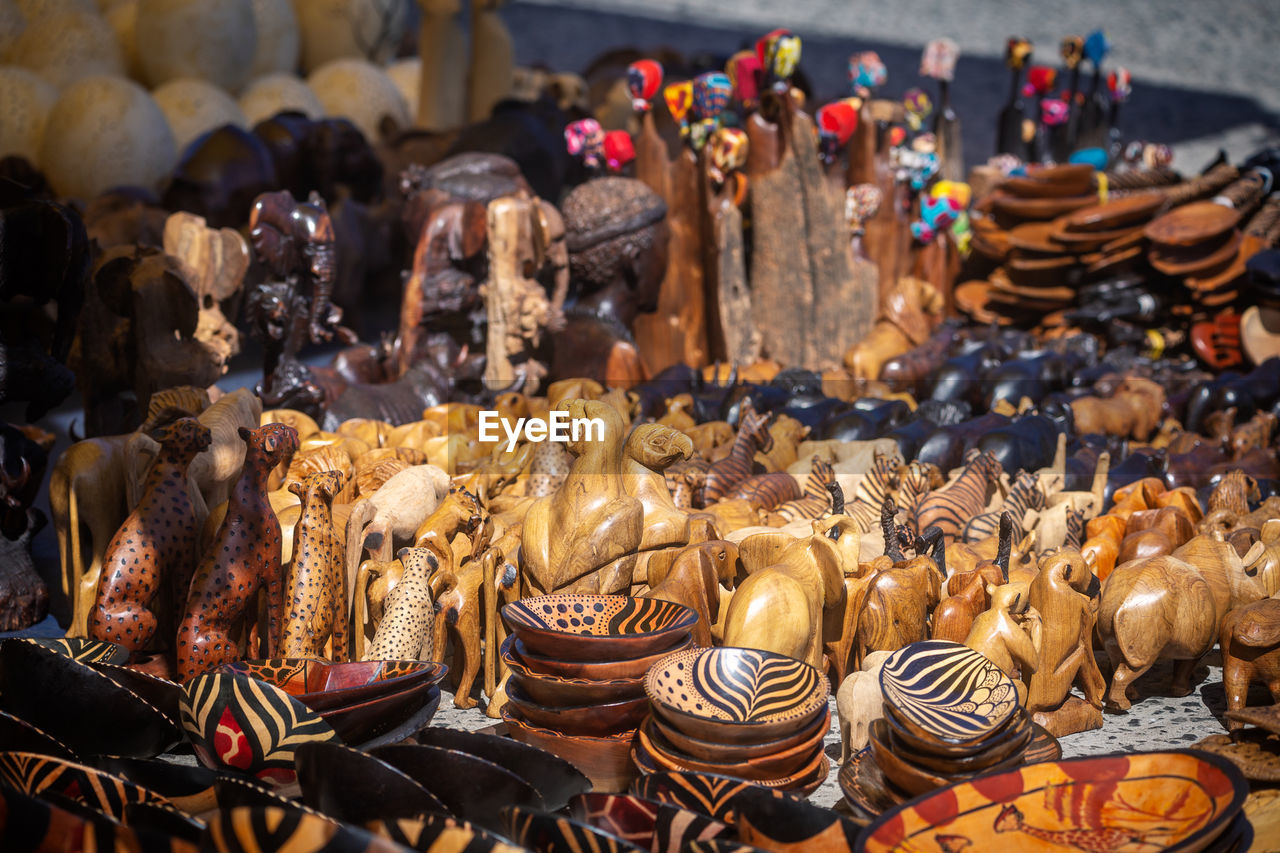 Close-up of wooden figurines for sale in market