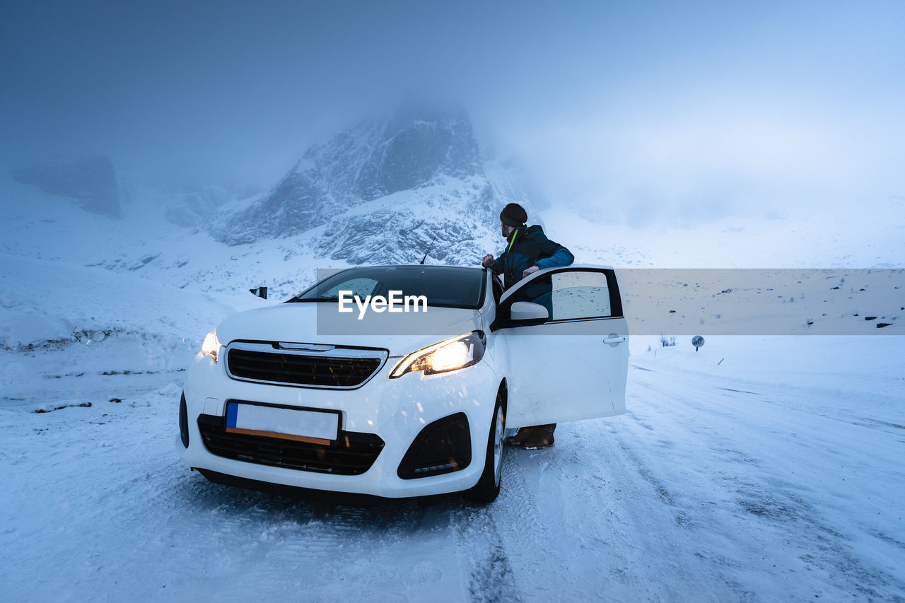 MOTOR SCOOTER ON SNOWCAPPED MOUNTAIN