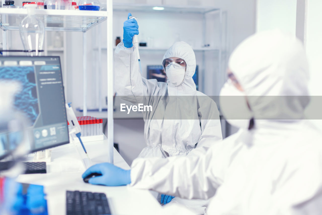 rear view of scientist working in laboratory