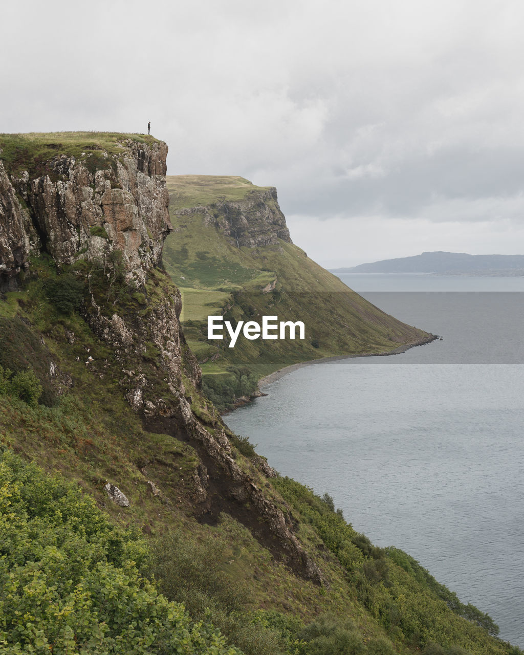 Scenic view of sea and mountains against sky