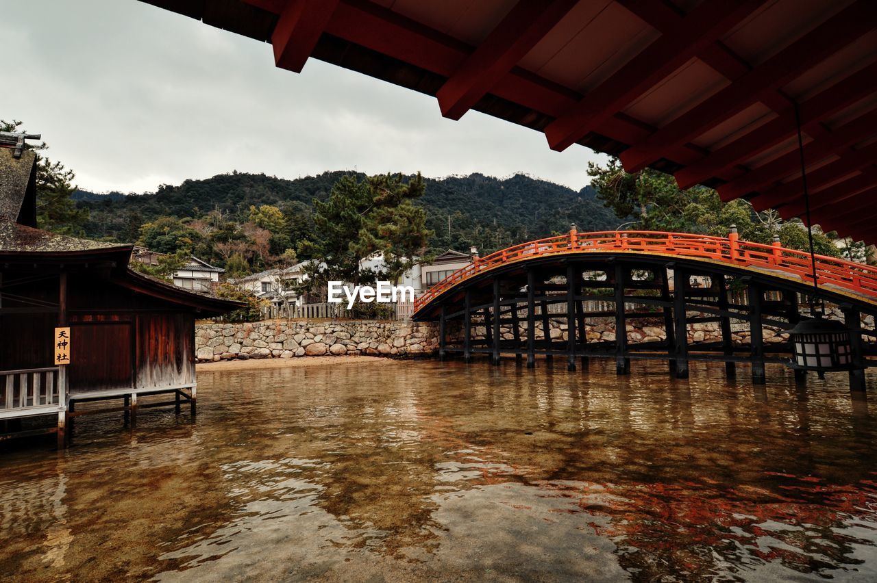 Arched footbridge over sea at itsukushima shrine
