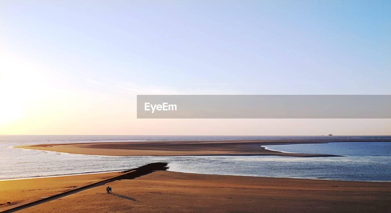 Scenic view of beach against clear sky