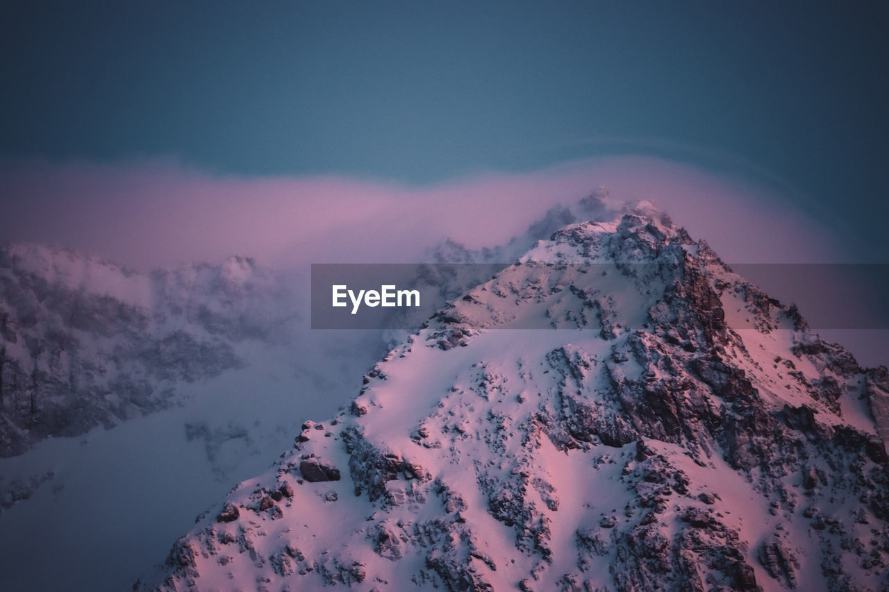 Scenic view of snow covered mountains against sky