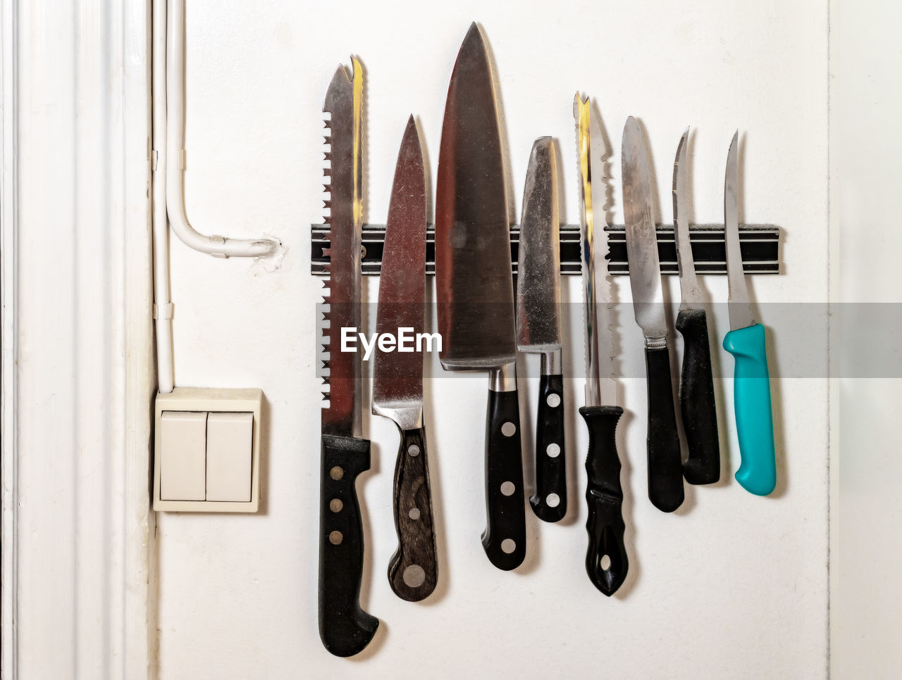 Various knife hanging in kitchen at home