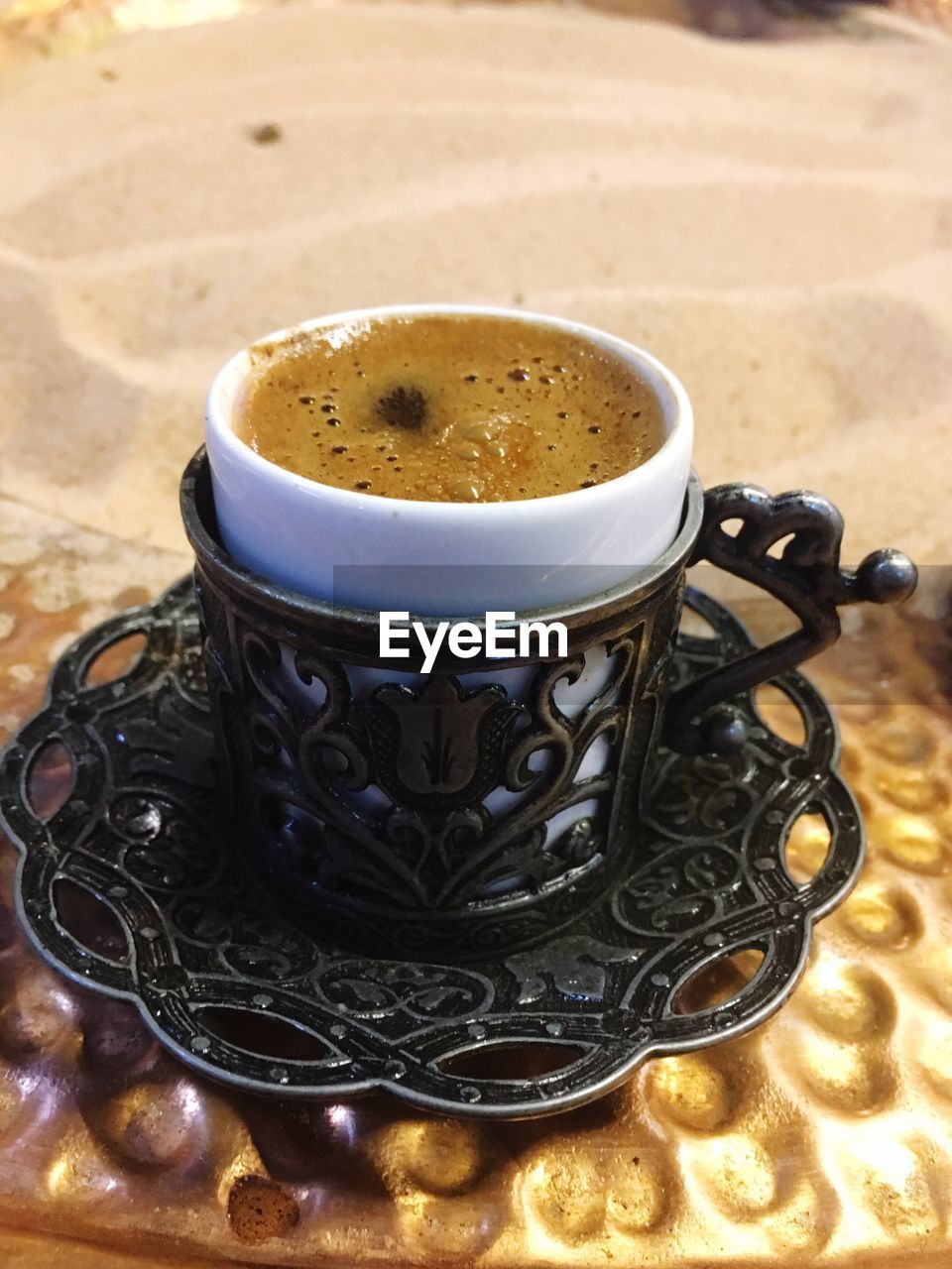 CLOSE-UP OF COFFEE WITH CUP ON TABLE