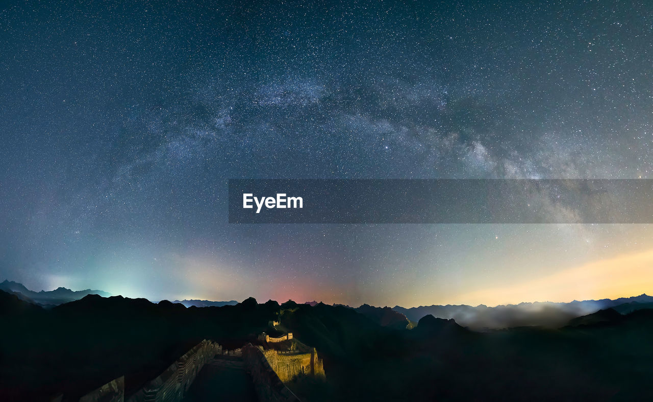 Scenic view of mountains against sky at night