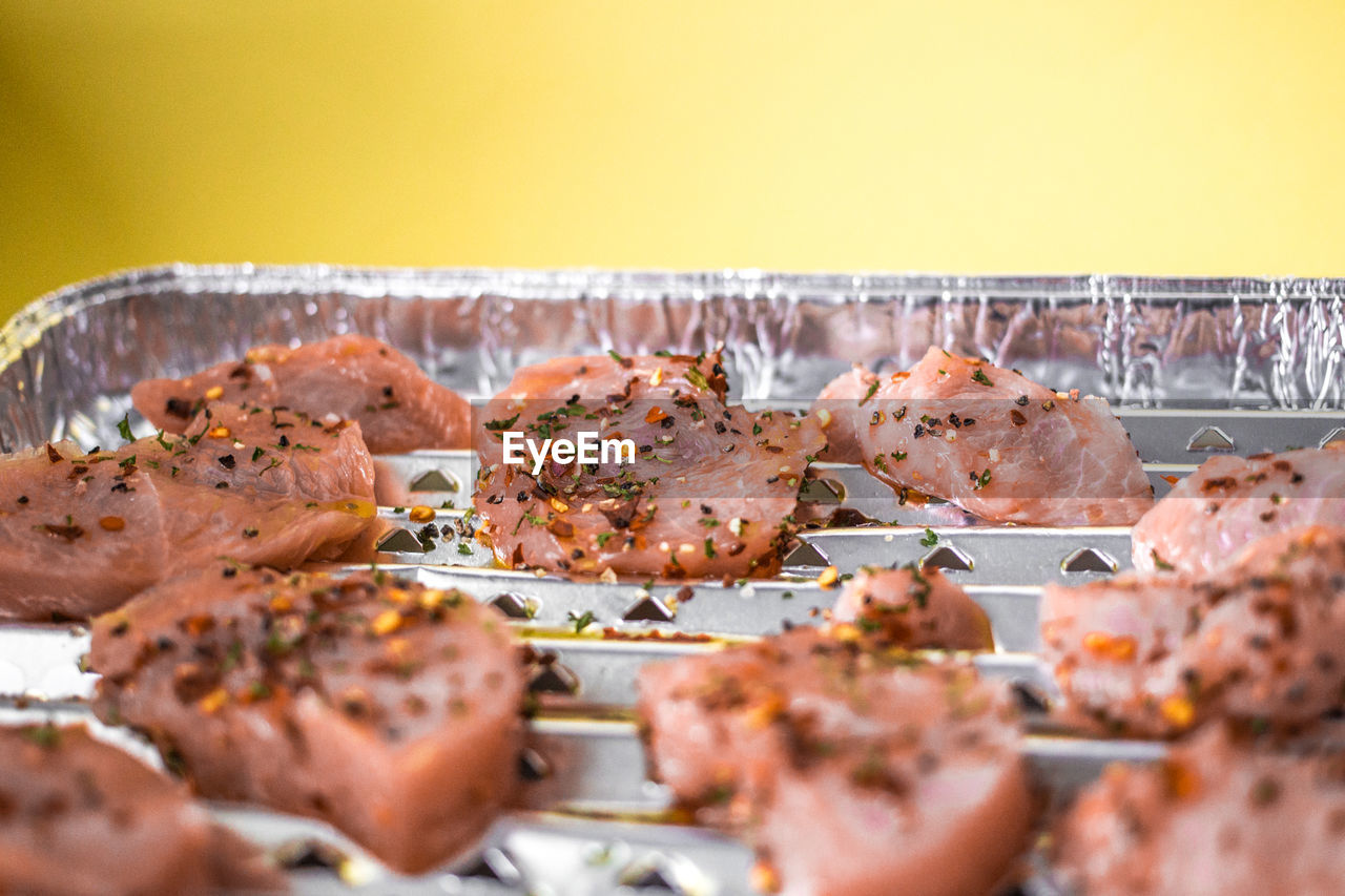 Close-up of raw meat on aluminum foil