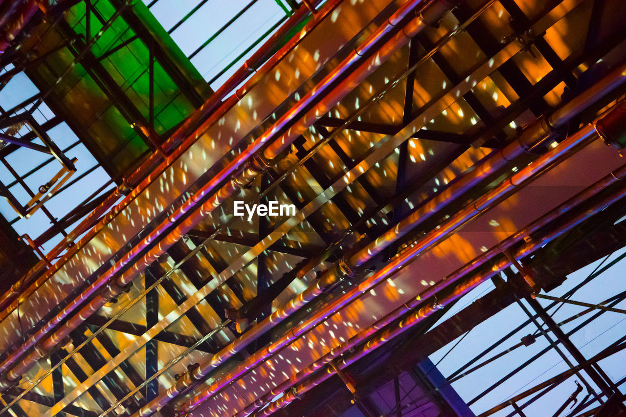 LOW ANGLE VIEW OF ILLUMINATED BRIDGE IN SKY