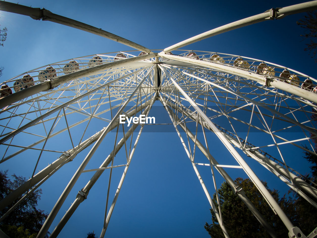 LOW ANGLE VIEW OF AMUSEMENT PARK AGAINST SKY
