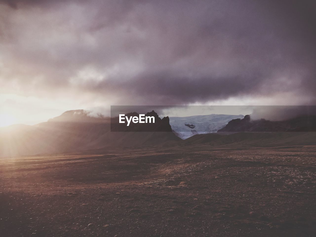 Scenic view of mountains against cloudy sky