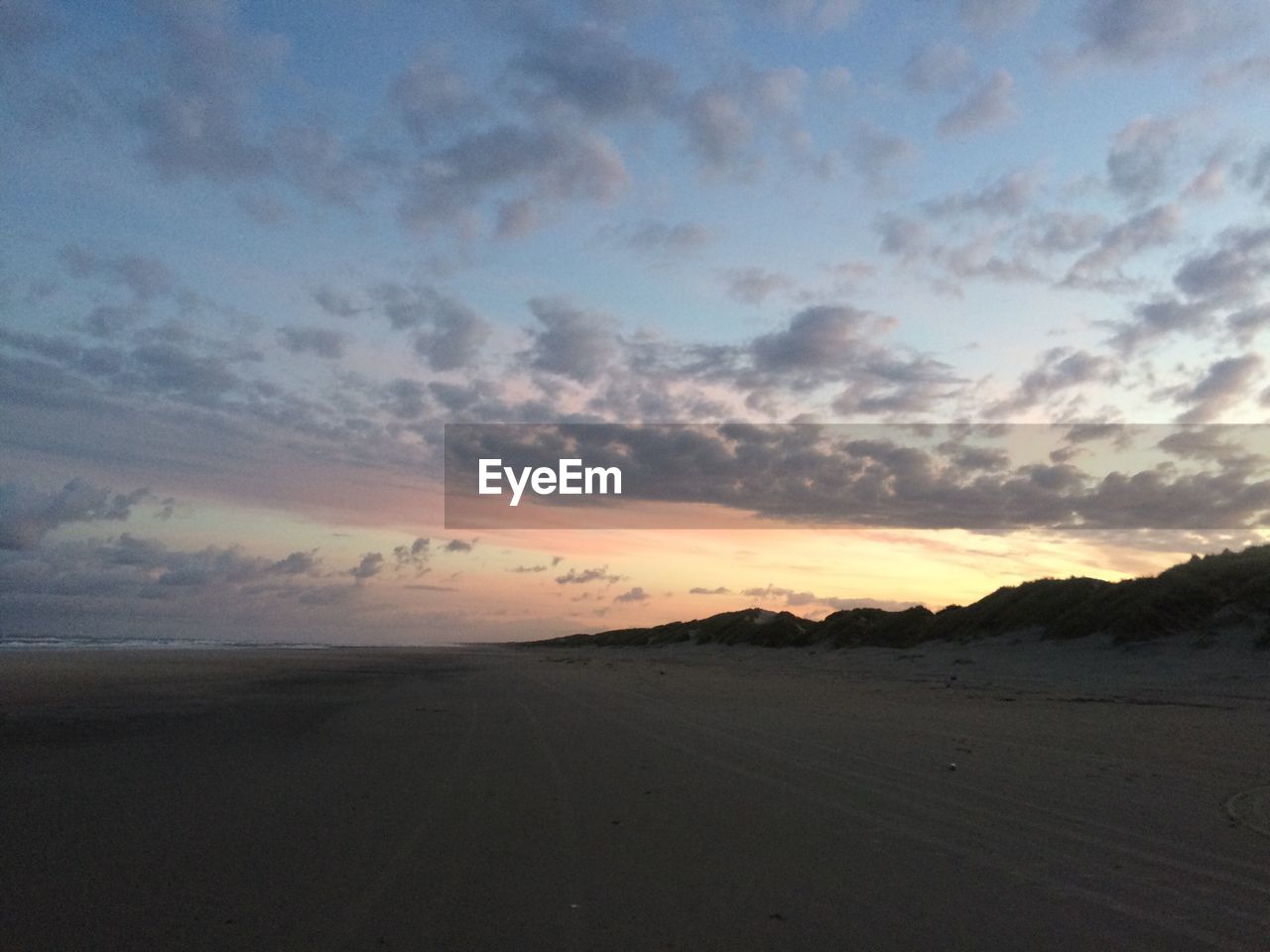 SCENIC VIEW OF DRAMATIC SKY OVER SAND DUNES