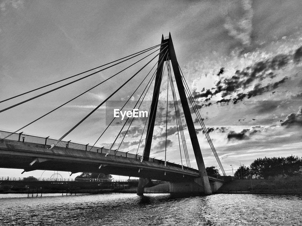 LOW ANGLE VIEW OF BRIDGE OVER RIVER AGAINST SKY