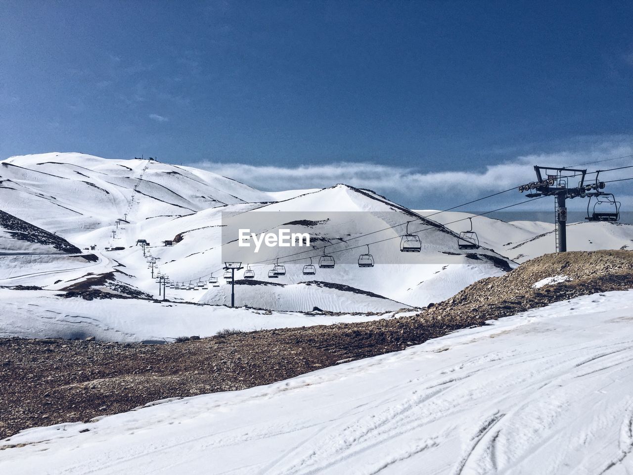 Snow covered mountain against blue sky