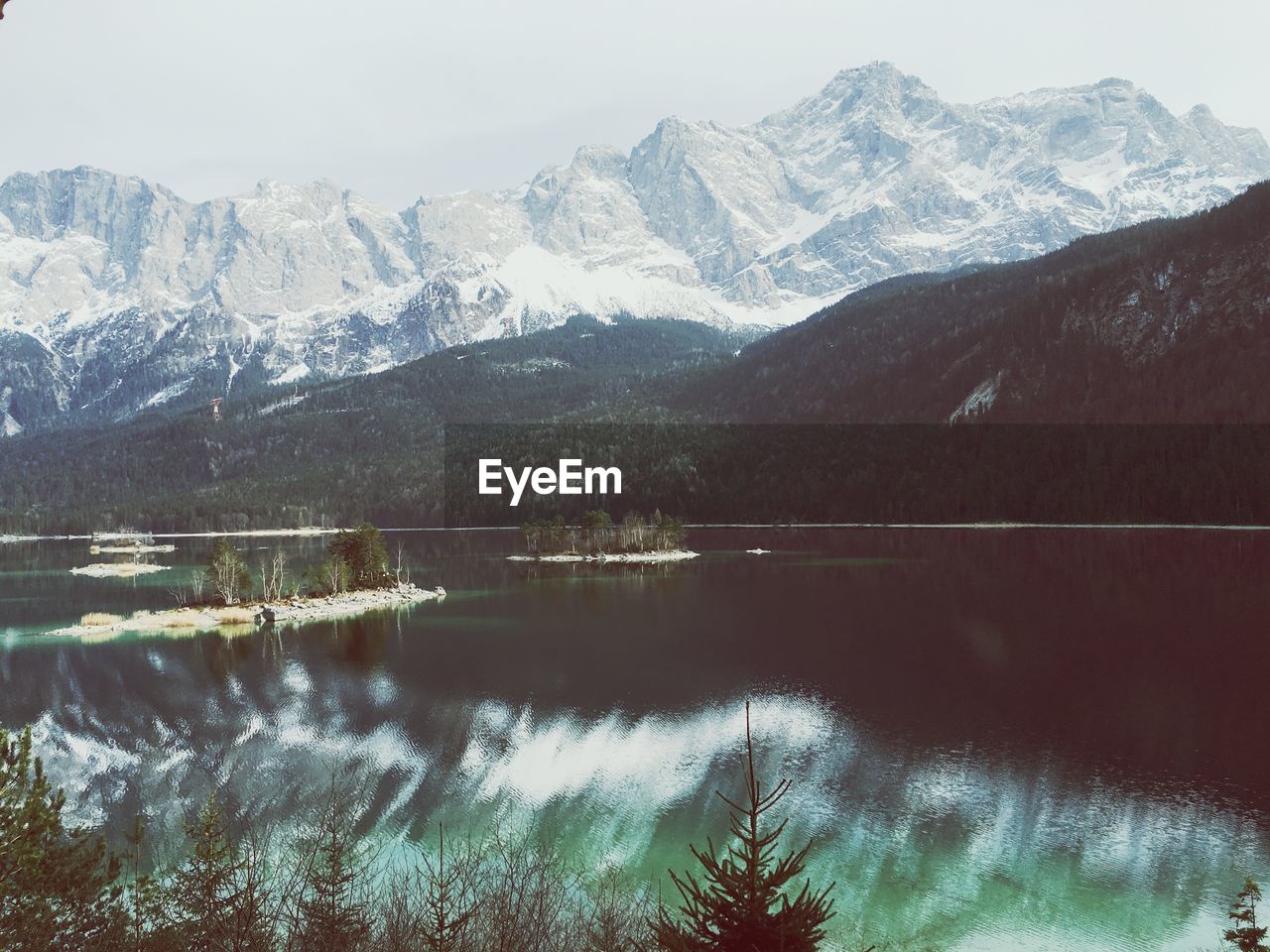 Scenic view of lake and mountains against sky