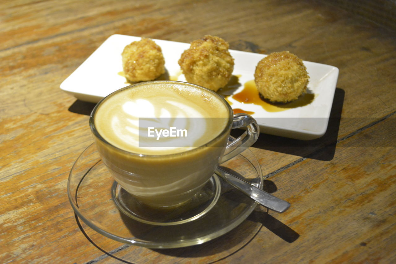 HIGH ANGLE VIEW OF COFFEE CUP AND COOKIES