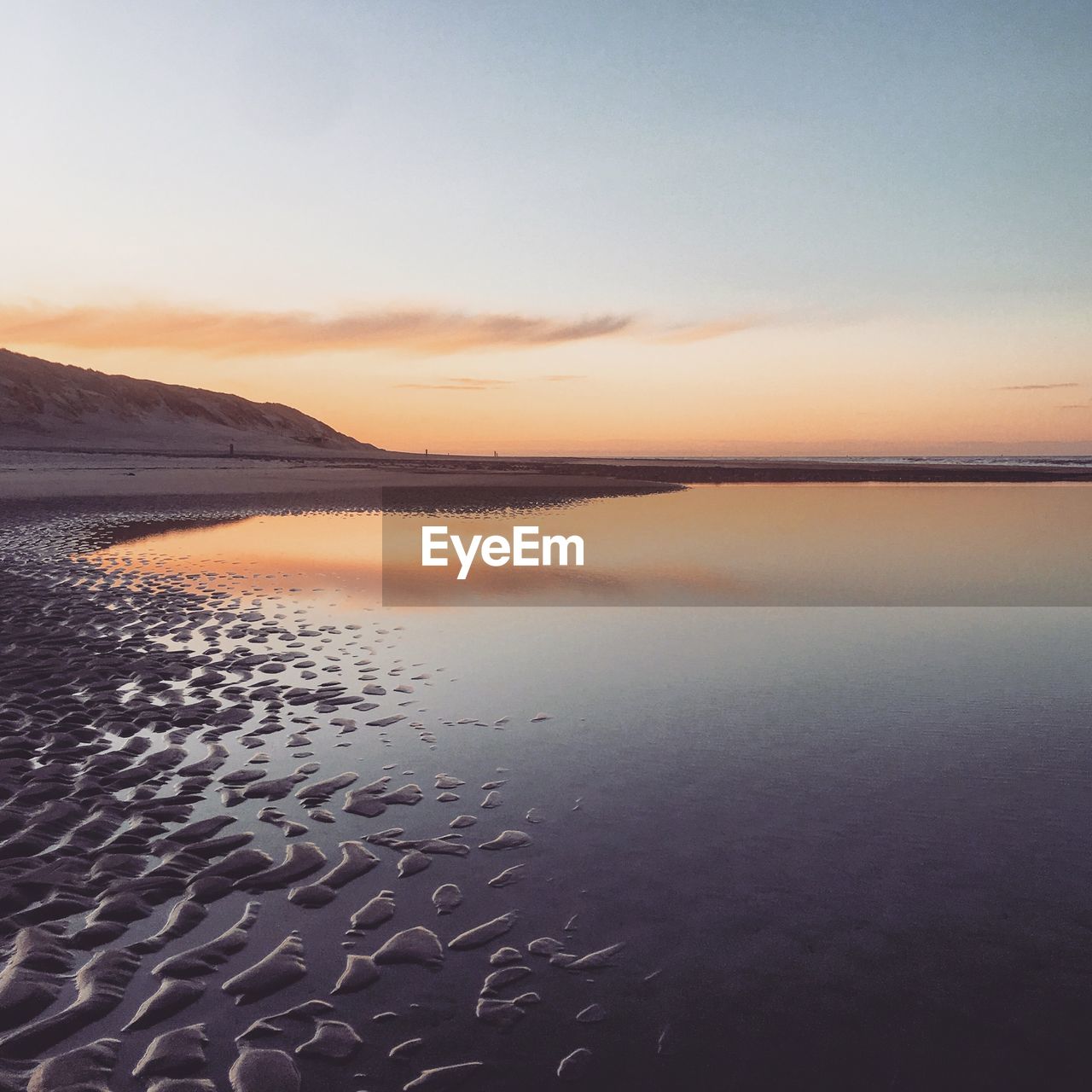 Scenic view of beach against sky during sunset