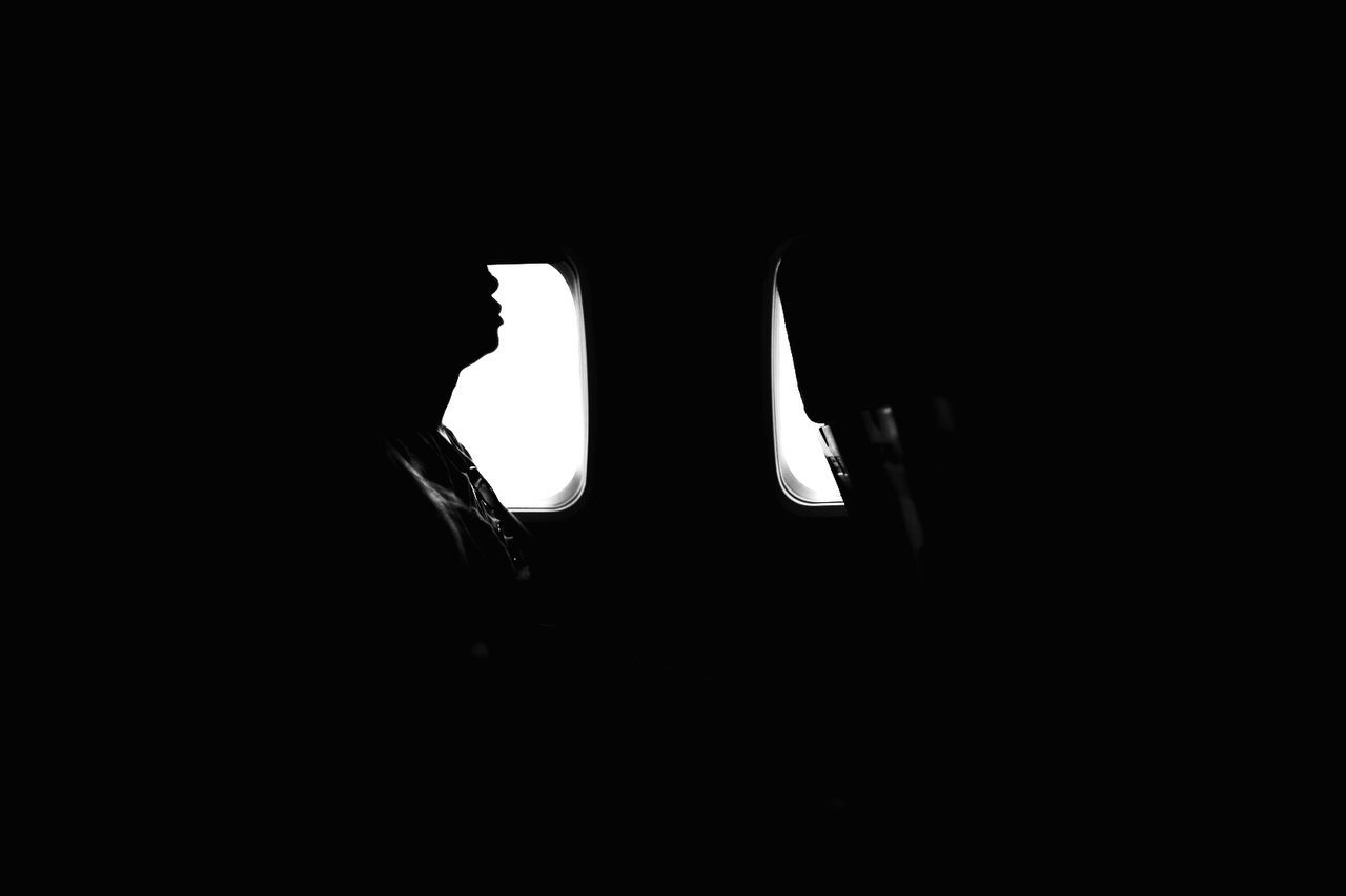 Silhouette person in airplane