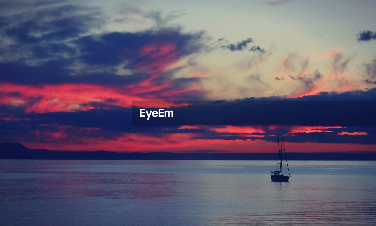 Scenic view of mediterranean sea against dramatic sky during sunrise