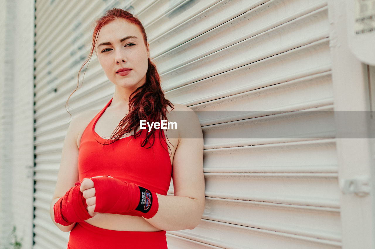 Portrait of a young woman boxer training outdoors in brooklyn street