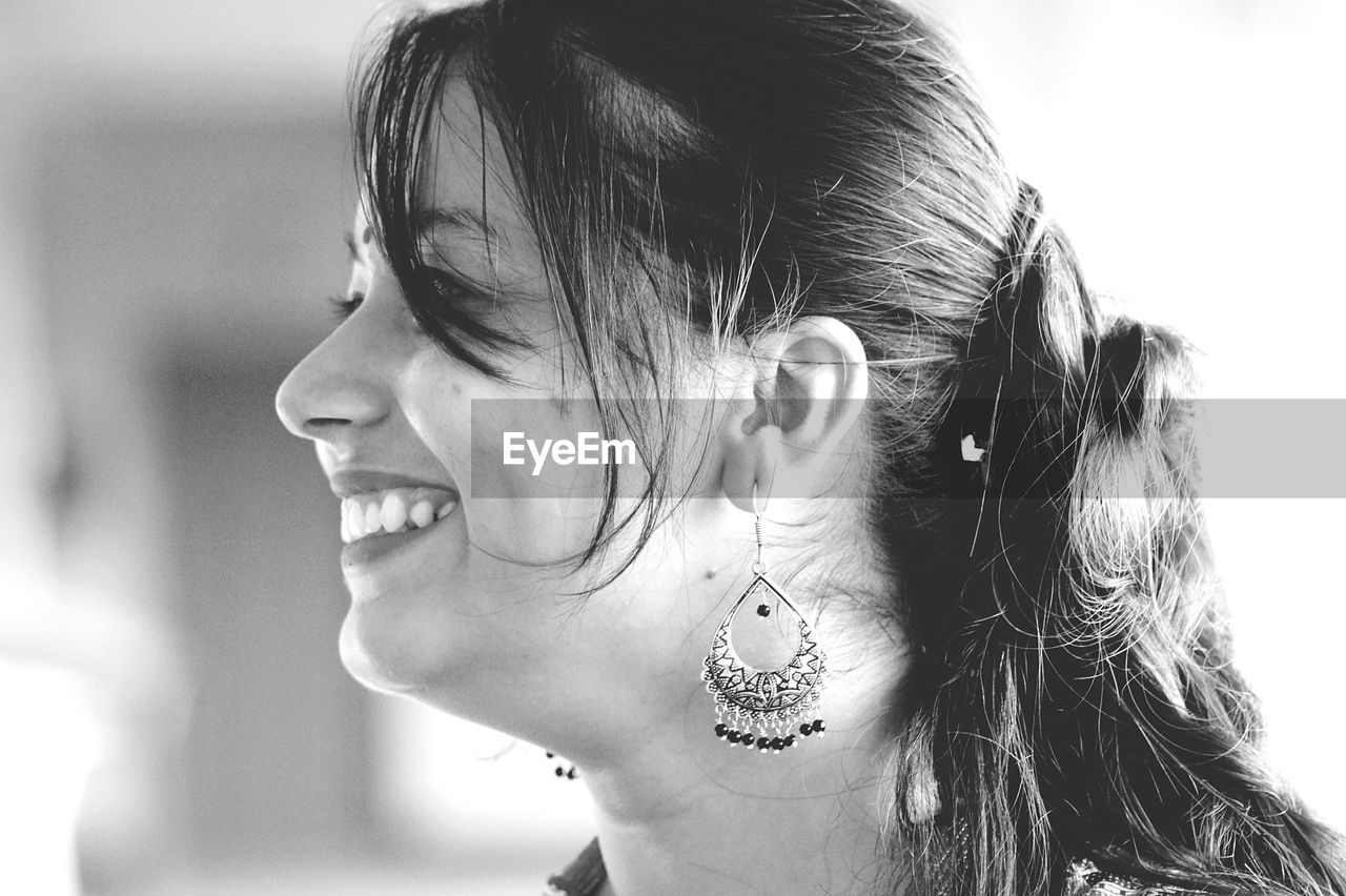 Close-up of smiling young woman looking away