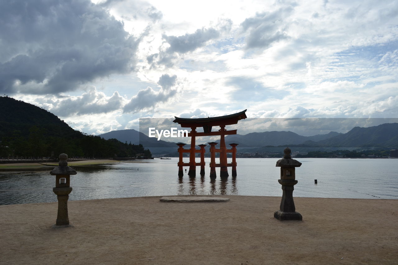 GAZEBO BY LAKE AGAINST SKY