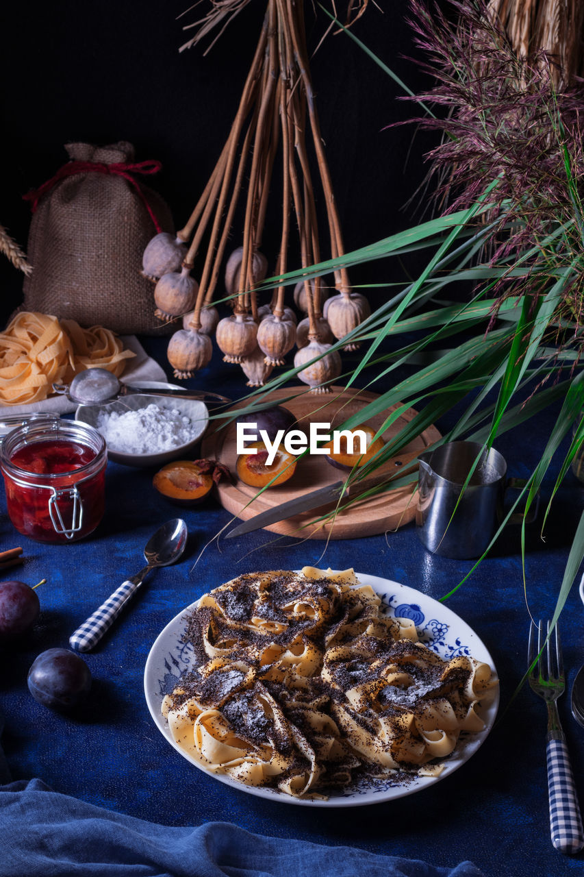 Sweet pasta dessert, noodles with poppy seeds and plum compote. traditional czech dessert.