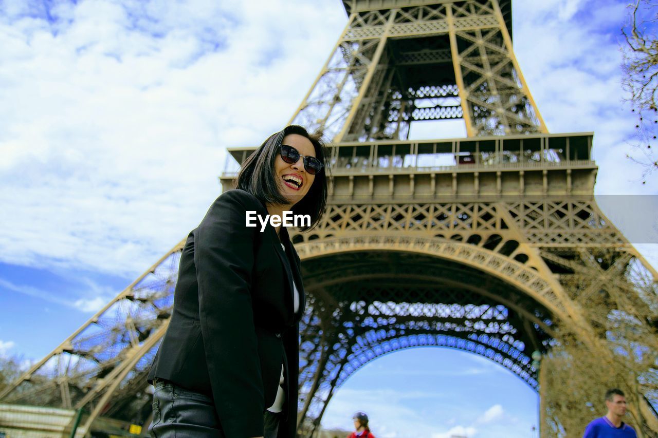 Low angle view of woman against eiffel tower