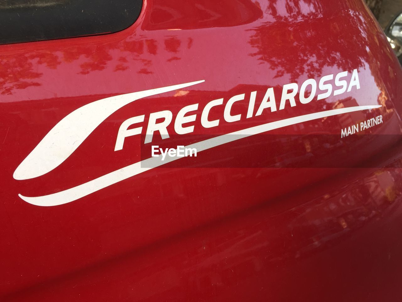 CLOSE-UP OF TEXT ON RED CAR