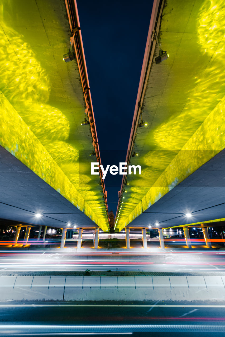 Low angle view of illuminated bridge at night