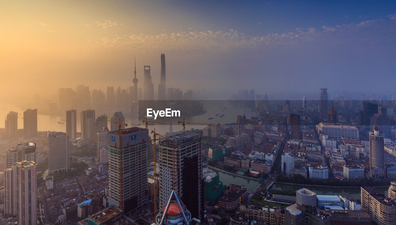 Scenic view of cityscape in foggy weather