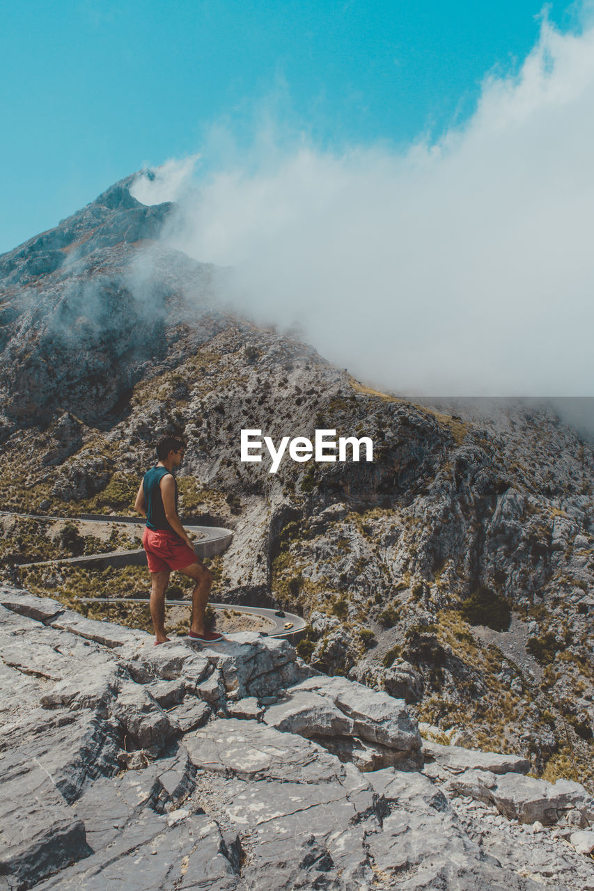 Young man standing on mountain