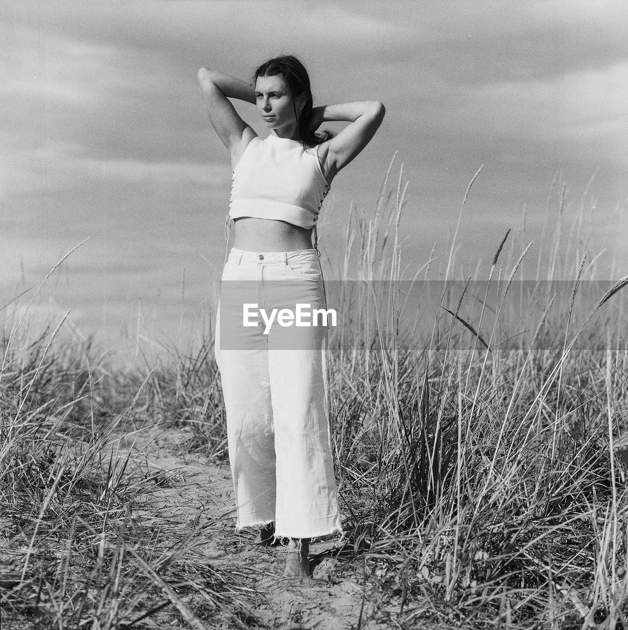 Rear view of woman standing on coast