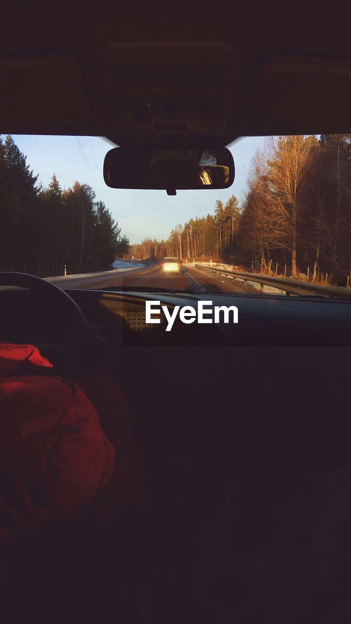 SILHOUETTE OF CAR ON ROAD