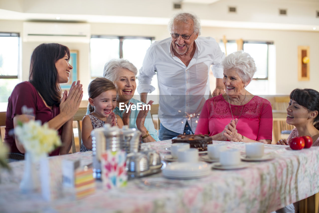 Grandparents celebrating a birthday with their granddaughter