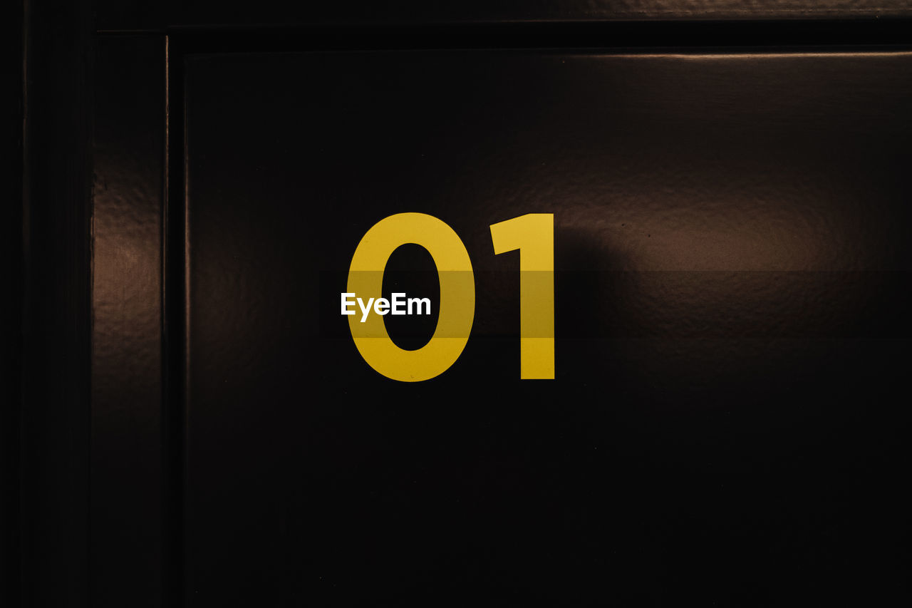 Close-up of number on black door