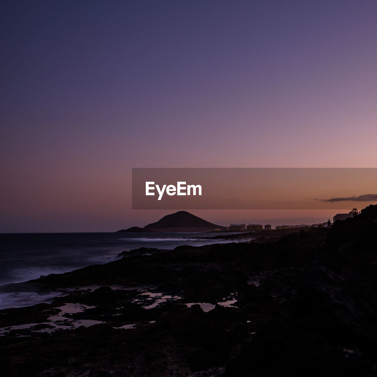 SCENIC VIEW OF BEACH AGAINST SKY DURING SUNSET