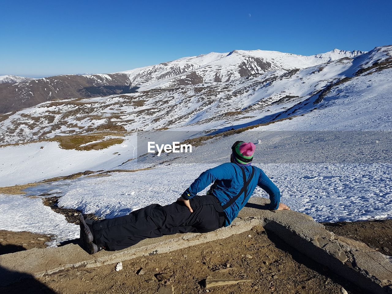 Full length of man looking at snowcapped mountains against sky